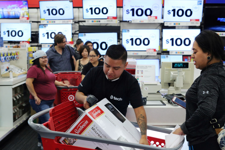 Image: An employee scans a purchase during Black Friday sales at a Target store in Culver City