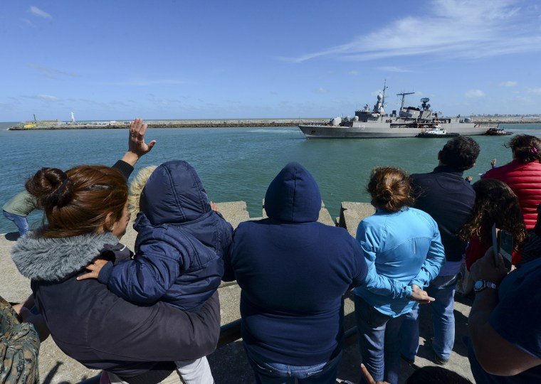 Image: People wave at the Argentine destroyer Sarandi as it leaves a Navy base in Mar del Plata, Argentina, to join the search of the missing submarine