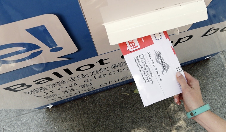 Image: A ballot is dropped into a voting box
