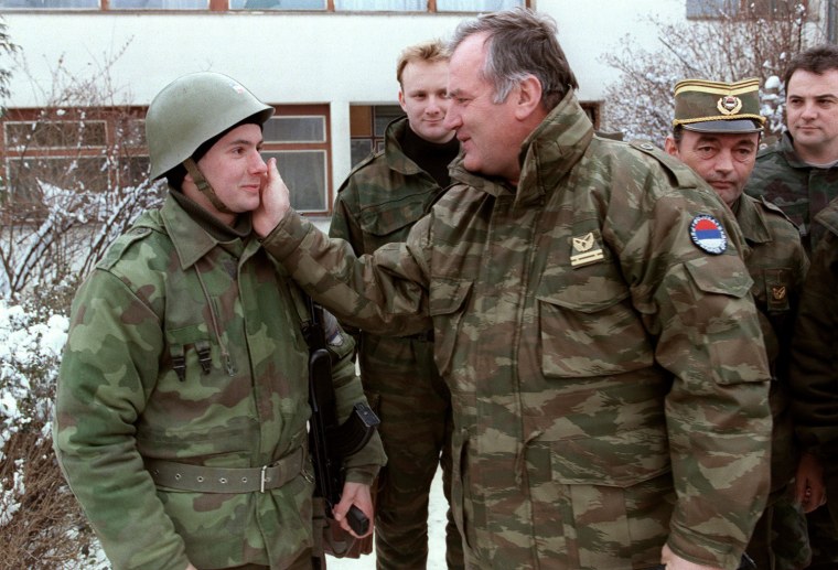 Image: Ratko Mladic pats one of his soldiers on the cheek at the Lukavica barracks