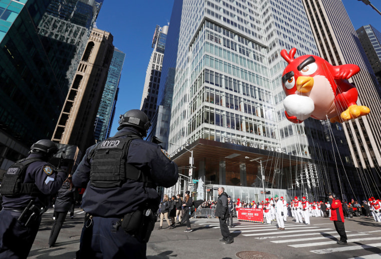 Image: New York Police Department officers stand guard for security as the Angry Birds Red balloon makes its way down 6th Ave during the 91st Macy's Thanksgiving Day Parade in the Manhattan borough of New York City