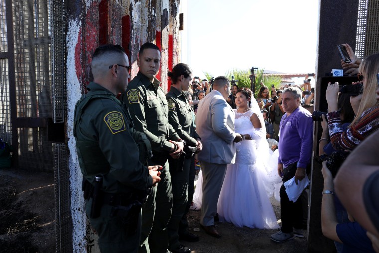 Image: U.S. resident Brian Houston marries Evelia Reyes as U.S. Border patrol agents open a single gate for in the border wall to allow selected families to visit along the U.S.-Mexico border in San Diego