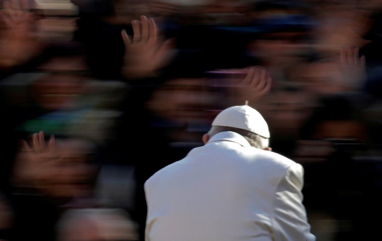 Image: Pope Francis waves as he arrives to lead the Wednesday general audience in Saint Peter's square at the Vatican