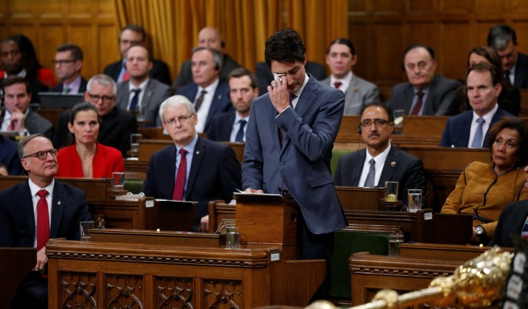 Image: Canada's PM Trudeau wipes away tears while delivering an apology to members of the LGBT community on Parliament Hill in Ottawa