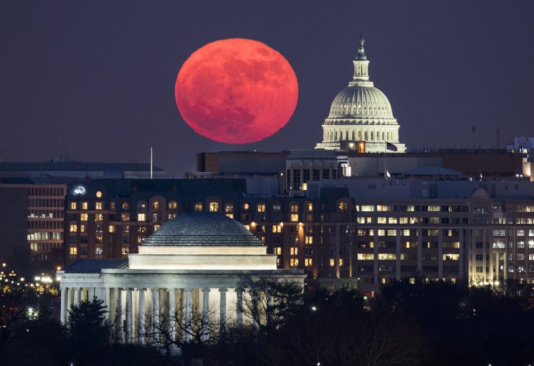 Image: The supermoon rises behind the U.S. Capitol and the Jefferson Memorial in Washington