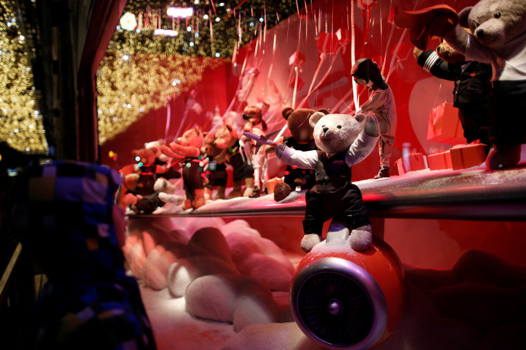 Image: A child looks at a Christmas holiday window display outside the Printemps department store in Paris