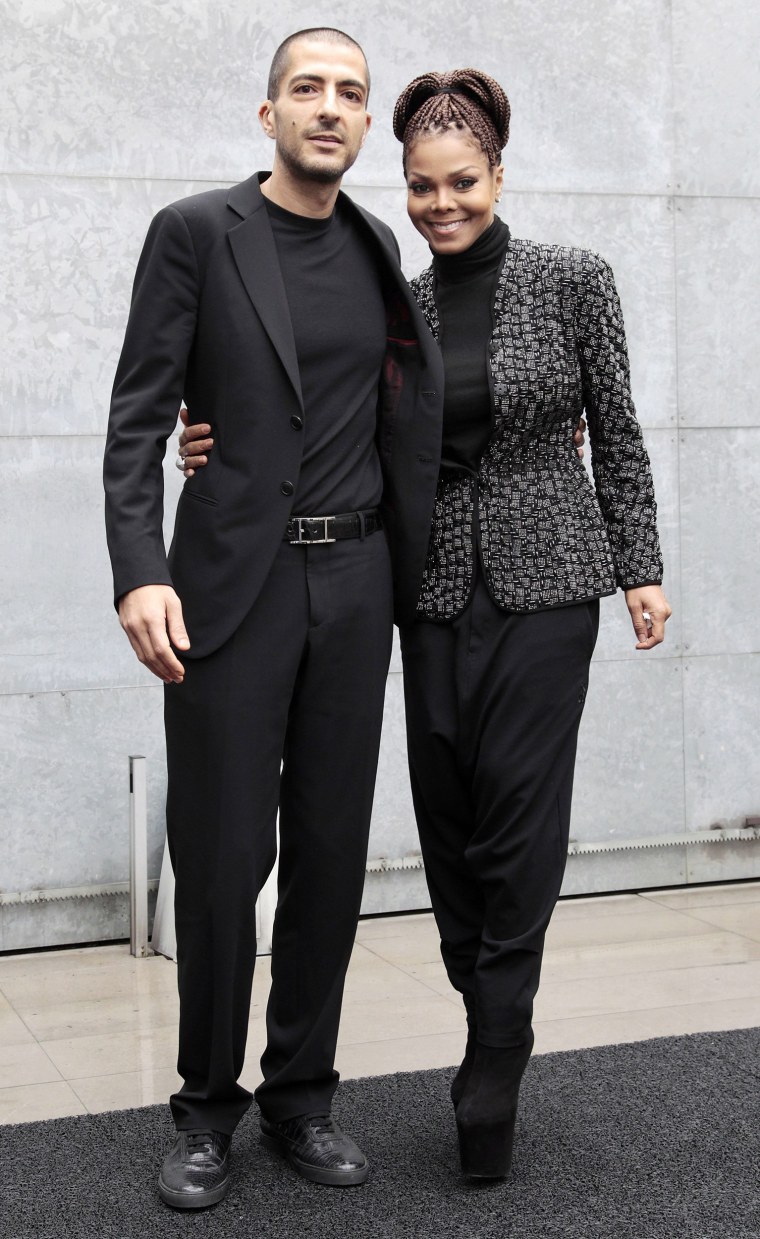 Image: Singer Jackson and boyfriend Al Mana arrive to attend the Giorgio Armani Autumn/Winter 2013 collection at Milan Fashion Week
