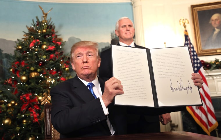Image: Vice President Mike Pence, right, watches as President Donald J. Trump holds up his proclamation