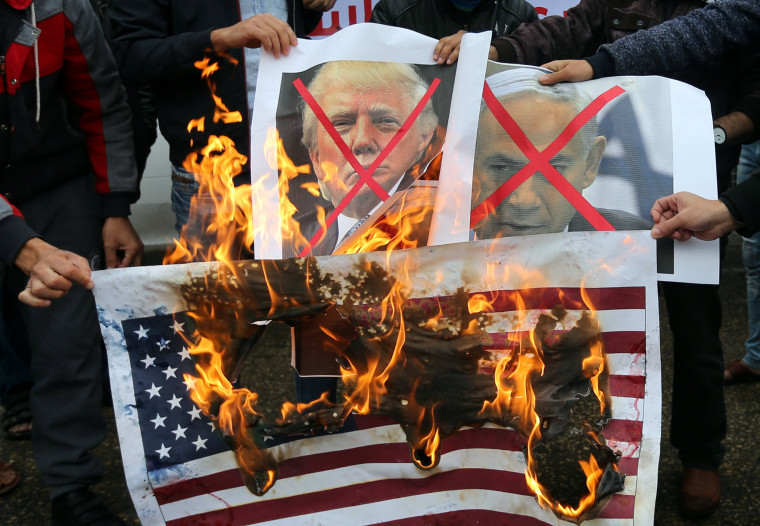 Image: Palestinians burn posters depicting Netanyahu and Trump during a protest against the U.S. intention to move its embassy to Jerusalem and to recognize the city of Jerusalem as the capital of Israel, in Rafah in the southern Gaza Strip