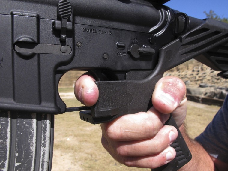 Shooting instructor Frankie McRae demonstrates the grip on an AR-15 rifle fitted with a "bump stock" at his 37 PSR Gun Club in Bunnlevel, North Carolina on Oct. 4, 2017.