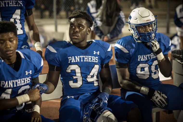 C.E. King's Roderick Crumedy, center, gets support from a teammate on the sidelines during the game with Kingwood.