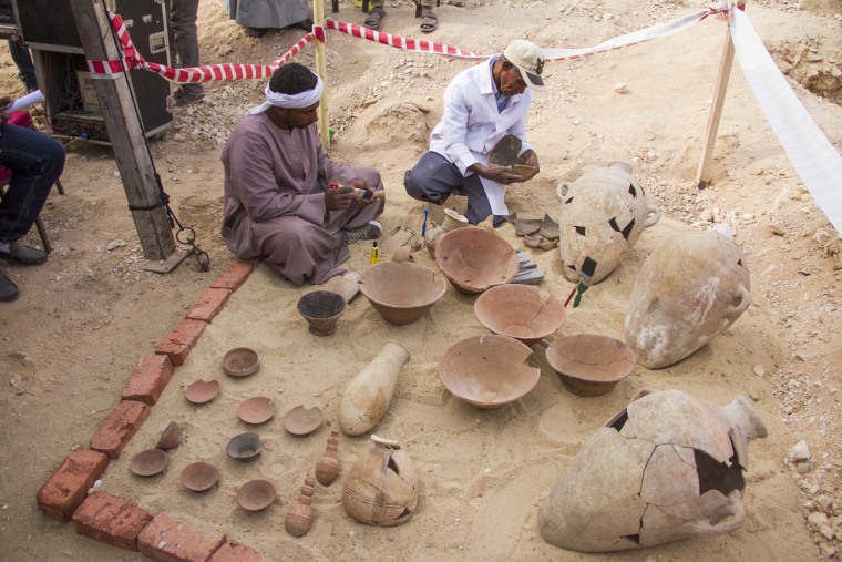 Image: Egyptian excavation workers restore pottery near a new found in a tomb in Draa Abul Naga necropolis on Luxor's West Bank known as \"KAMPP 161\" in Luxor, Egypt, Dec. 9, 2017.