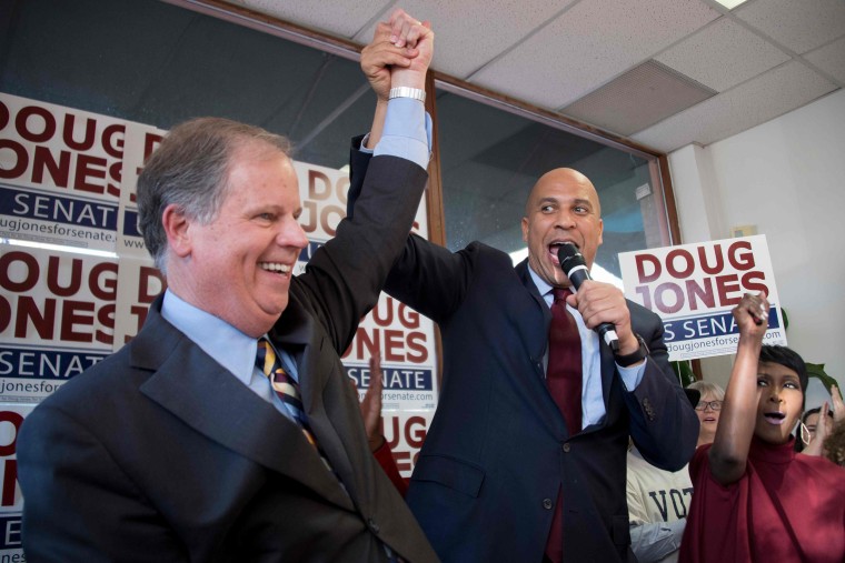 Image: Sen. Cory Booker raises Democratic Senatorial candidate Doug Jones' arm