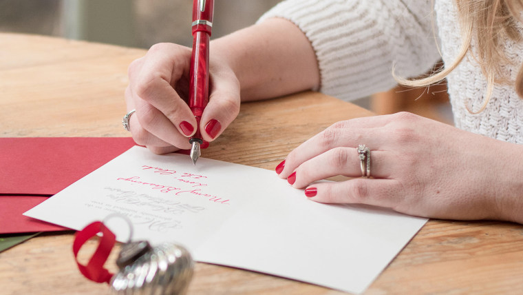 Woman writes Christmas cards