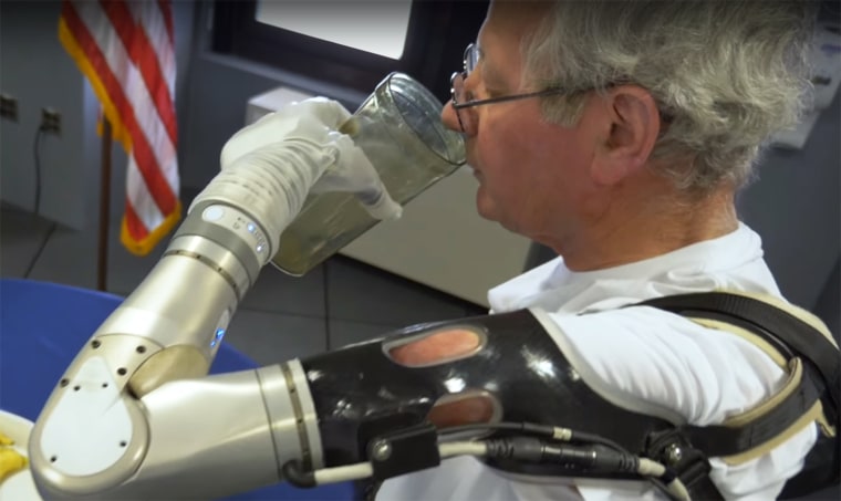 Image: A veteran drinks a glass of water with DARPA's LUKE Arm