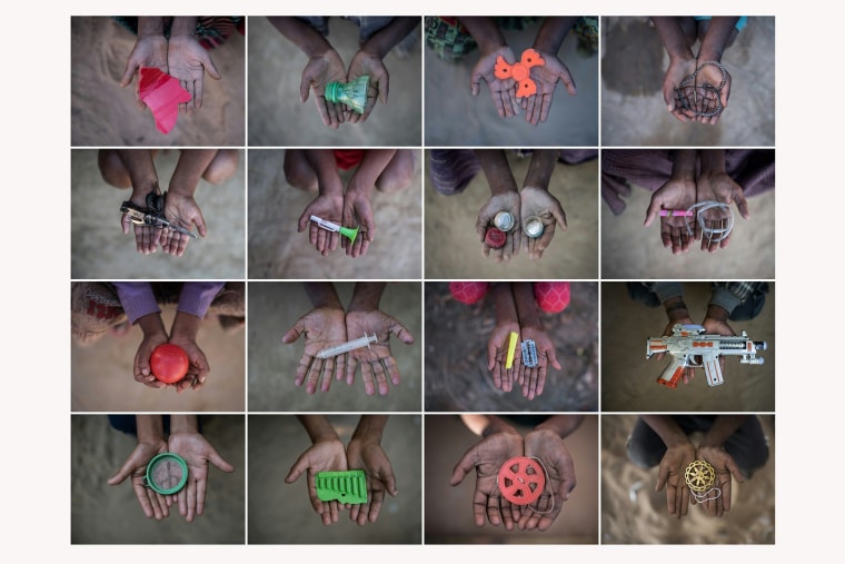 Image: Rohingya children hold objects they use as toys to play with in refugee camps in Bangladesh's Cox's Bazar