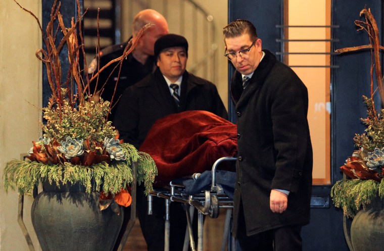 Image: One of two bodies is removed from the Sherman's home in Toronto