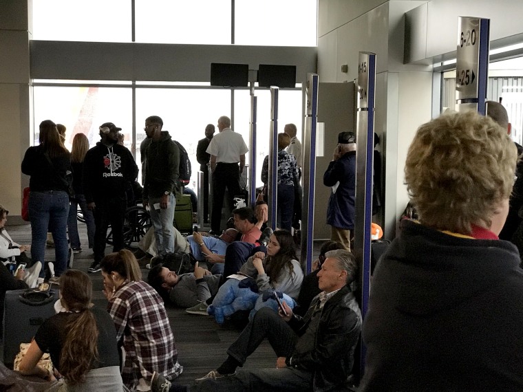 Image: Passengers sit stranded at the Atlanta airport, Dec. 17, 2017.