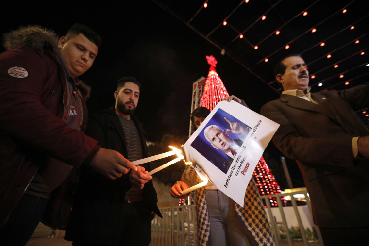 Image: Palestinians burn the picture of U.S. Vice President Mike Pence during a protest against Trump's decision to announce Jerusalem as the capital of Israel and amid the expected visit of Pence in the West Bank city of Bethlehem, Dec. 17, 2017.