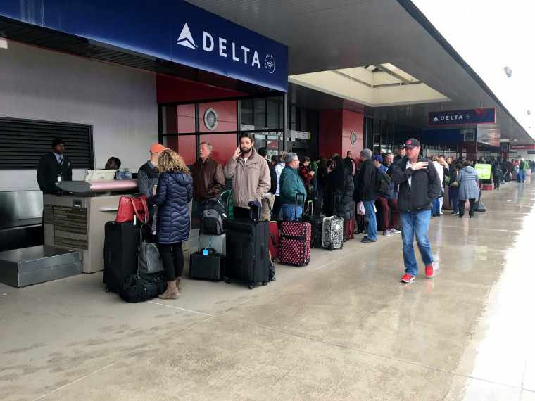Image: Passengers wait in line at the Atlanta airport, Dec. 17, 2017.