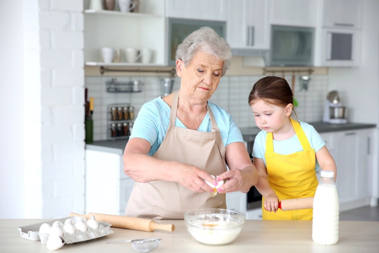 Grandparents cooking with grandkids.