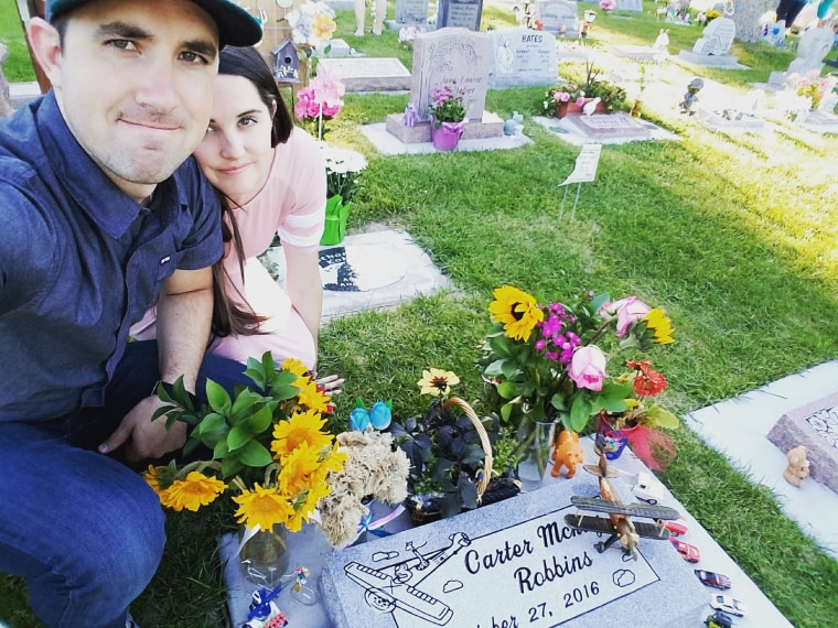 Brandon and Caitlin Robbins visit the grave site of their son Carter, who was stillborn in 2016.