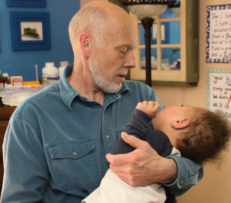 Mark Salchert holds Charlie in his arms.