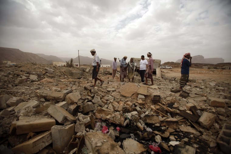 Image: Tribesmen stand on the rubble of a building destroyed by a U.S. drone air strike