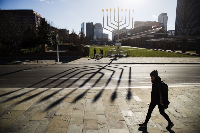 Image: A woman passes by a menorah on Independence Mall in Philadelphia