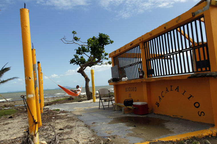 Image: A man rests in a hammock in the Punta Santiago beachfront neighborhood of Humacao