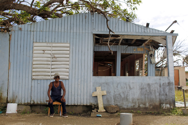 Image: Jose Luis Lluveras, 74, sits in front of his home that was destroyed during Hurricane Maria