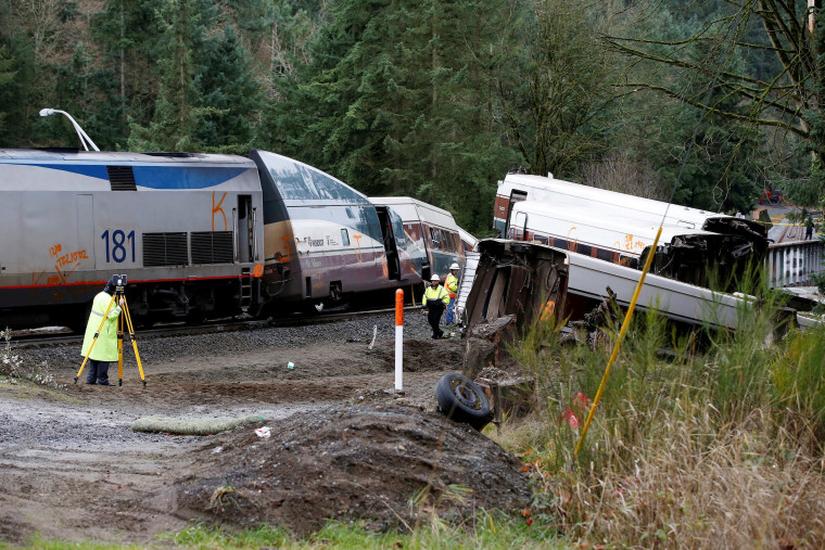Image: Investigators begin analysis at the scene where an Amtrak passenger train derailed in DuPont