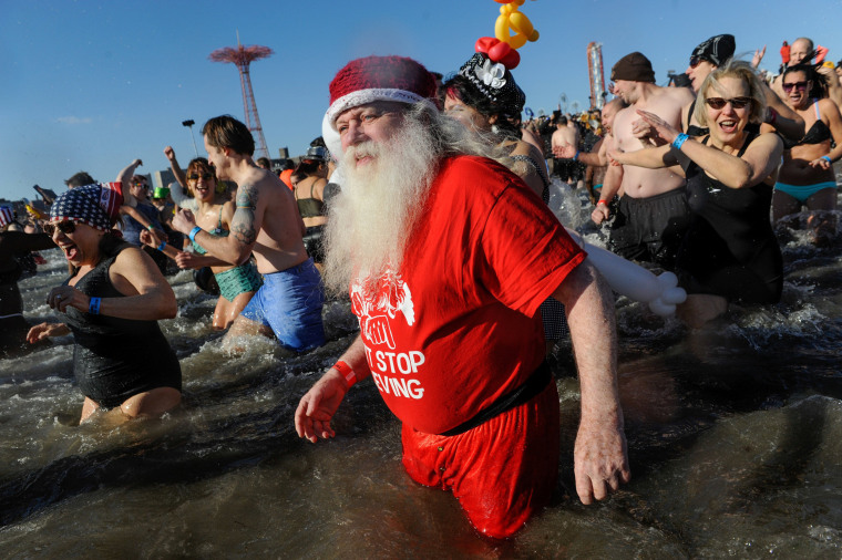 Image: A man dressed as Santa Claus participates in the annual Polar Bear Plunge in Coney Island in the Brooklyn Borough of New York City