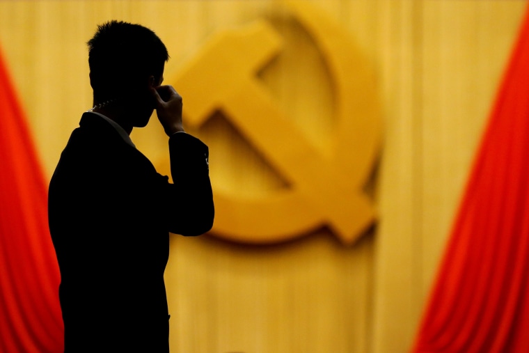Image: FILE PHOTO: A security agent takes position at the Great Hall of the People during the opening session of the 19th National Congress of the Communist Party of China in Beijing
