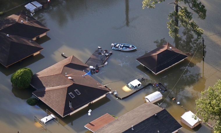 Image: A boat sits near flooded homes in the aftermath of Tropical Storm Harvey in Beaumont, Texas
