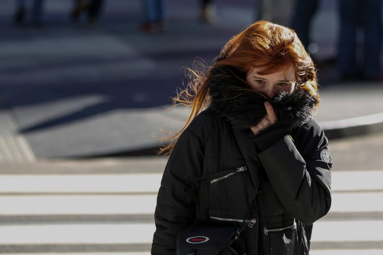 Image: A Woman Bundles Up Against the Cold Temperature