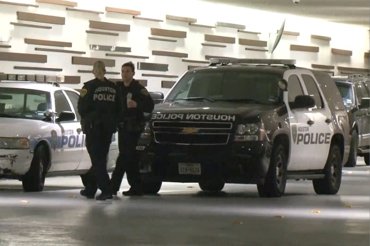 Image: Police talk outside the Hyatt Regency hotel in Houston