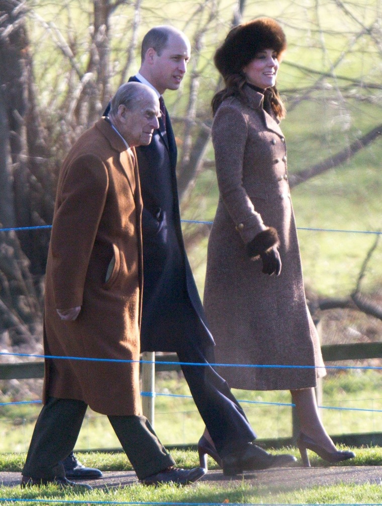 Kate, Duchess of Cambridge, wears a fur hat while walking with Prince William