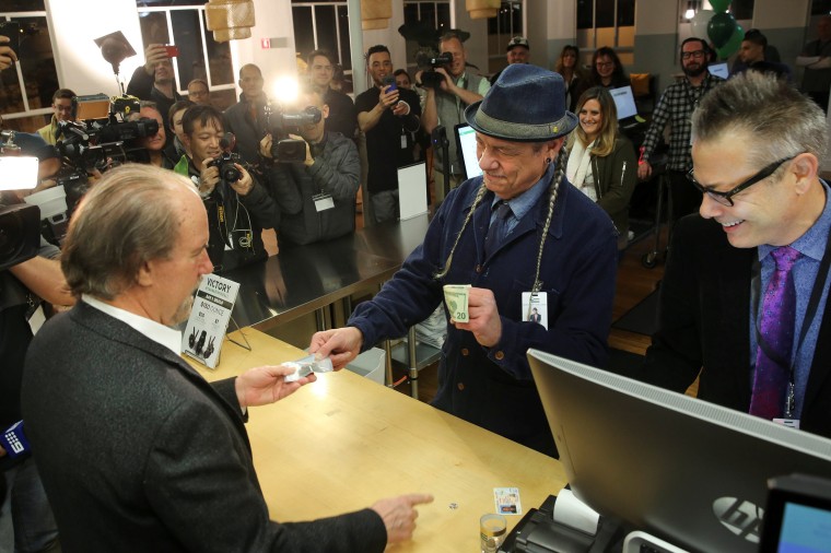 Image: Steve DeAngelo makes the first legal recreational marijuana sale to Henry Wykowski at Harborside in Oakland