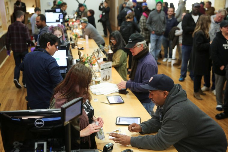 Image: Customers purchase marijuana at a dispensary in Oakland on the first day of legalized recreational marijuana sales in California