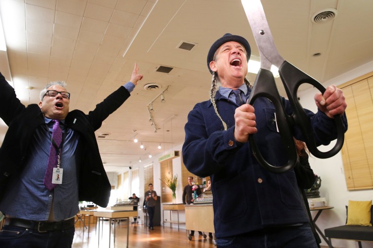 Image: Andrew and Steve DeAngelo celebrate after a ceremonial ribbon cutting on the first day of legalized recreational marijuana in Oakland