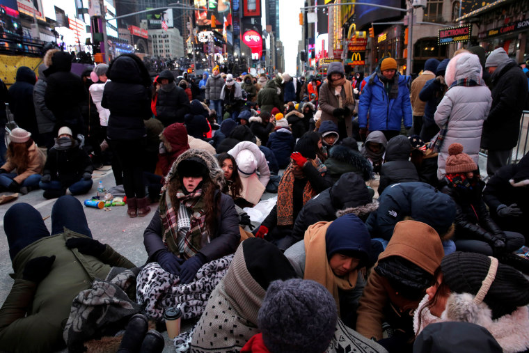 Image: Revelers gather in Times Square as a cold weather front hits the region ahead of New Year's celebrations in Manhattan, New York