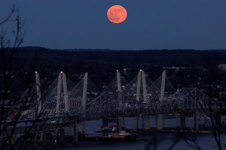 Image: A 'supermoon' full moon is seen above the Hudson River and the Mario M. Cuomo Bridge from Nyac