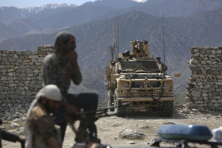 Image: U.S. forces and Afghan security police are seen near the site of a U.S. bombing in Achin, Afghanistan