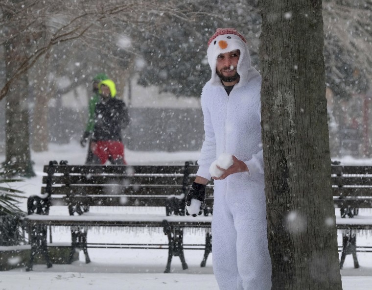 Image: With snowballs in hand, Anthony Arcuri seeks unsuspecting targets at Marion Square in Charleston