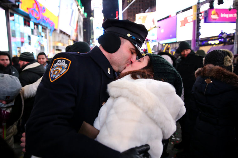 Image: A couple kisses while they celebrate the New Year in Times Square in New York