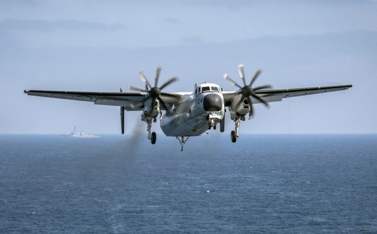 Image: A C-2A Greyhound assigned to the Providers of Fleet Logistics Support Squadron (VRC) 30, prepares to land on the flight deck aboard the aircraft carrier USS Theodore Roosevelt (CVN 71) on Aug. 22, 2017.