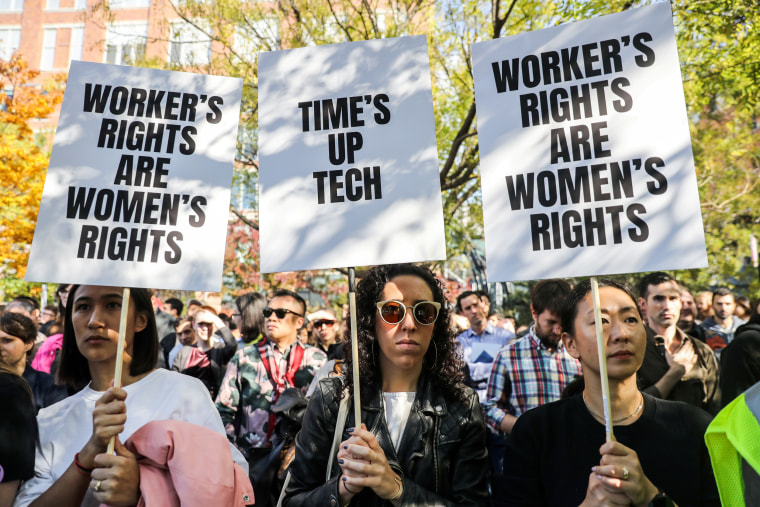 Workers hold signs outside 14th Street Park across the Google offices after walking out as part of a global protest over workplace issues in New York