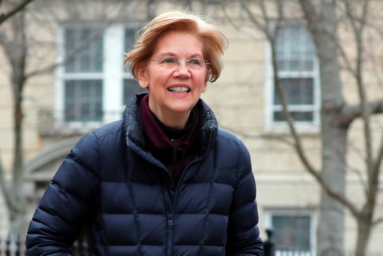 Senator Warren walks to speak to reporters outside her home in Cambridge