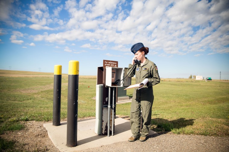 Image: Captain Amber Moore, 28, prepares to enter a capsule hidden 60 to 80 feet underground, where Air Force "missileers" like her control nuclear-capable intercontinental ballistic missiles, or ICBMS, in Minot, North Dakota.